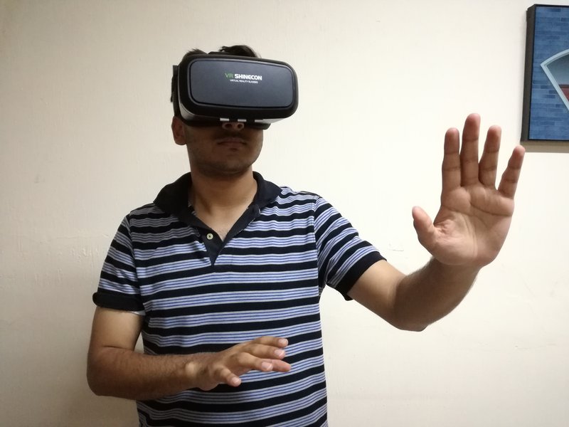 Testing head movement on VR glasses to ensure smooth movement.